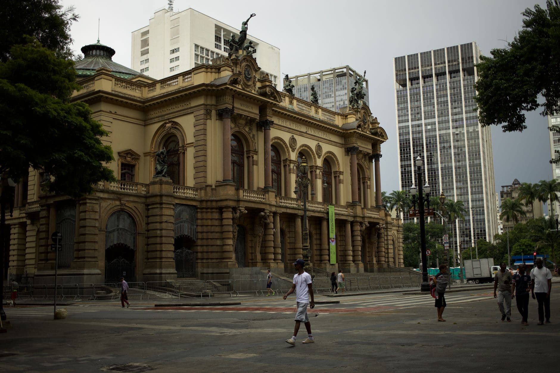 The grand architecture of São Paulo's Municipal Theater captured with city life bustling around.