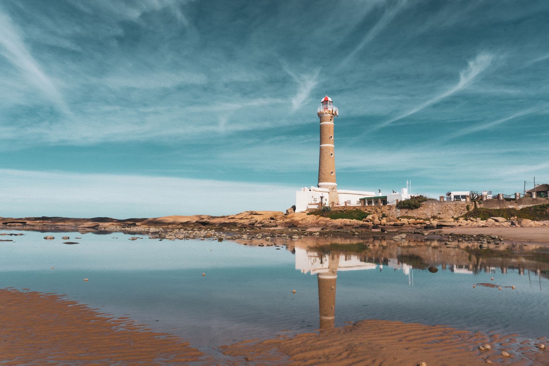 Beautiful seaside view of Faro de José Ignacio lighthouse reflecting in the calm water.