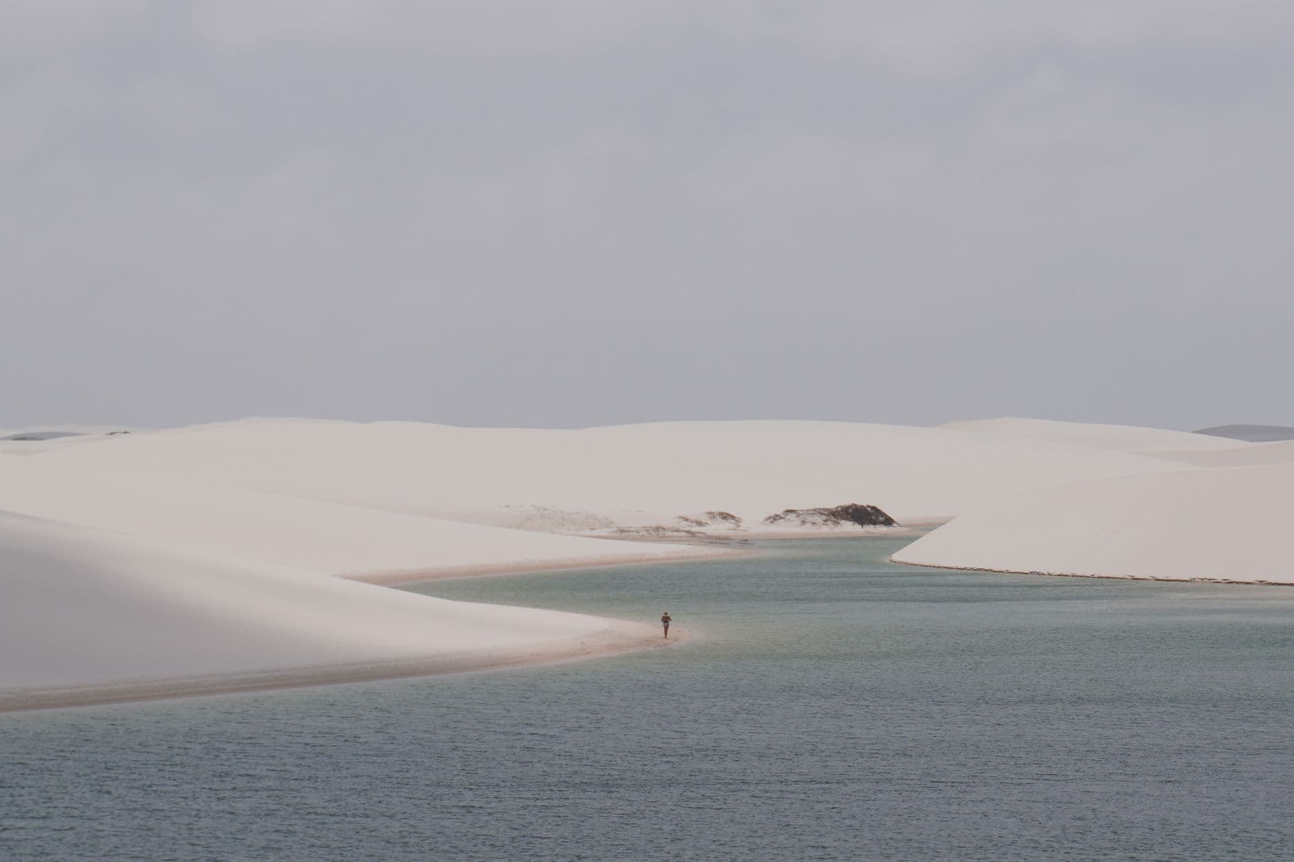 Peaceful view of Atins' sand dunes and lagoons in Lençóis Maranhenses National Park, Brazil.