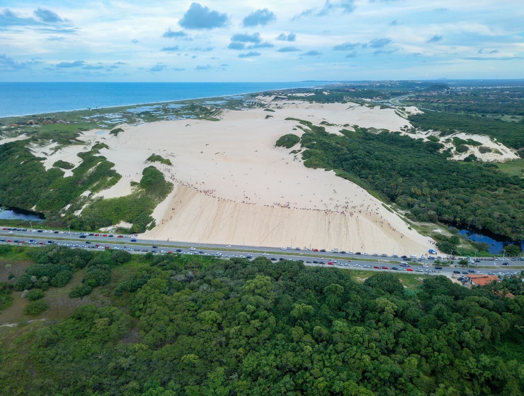 A breathtaking aerial photo of Fortaleza's sand dunes meeting the ocean.