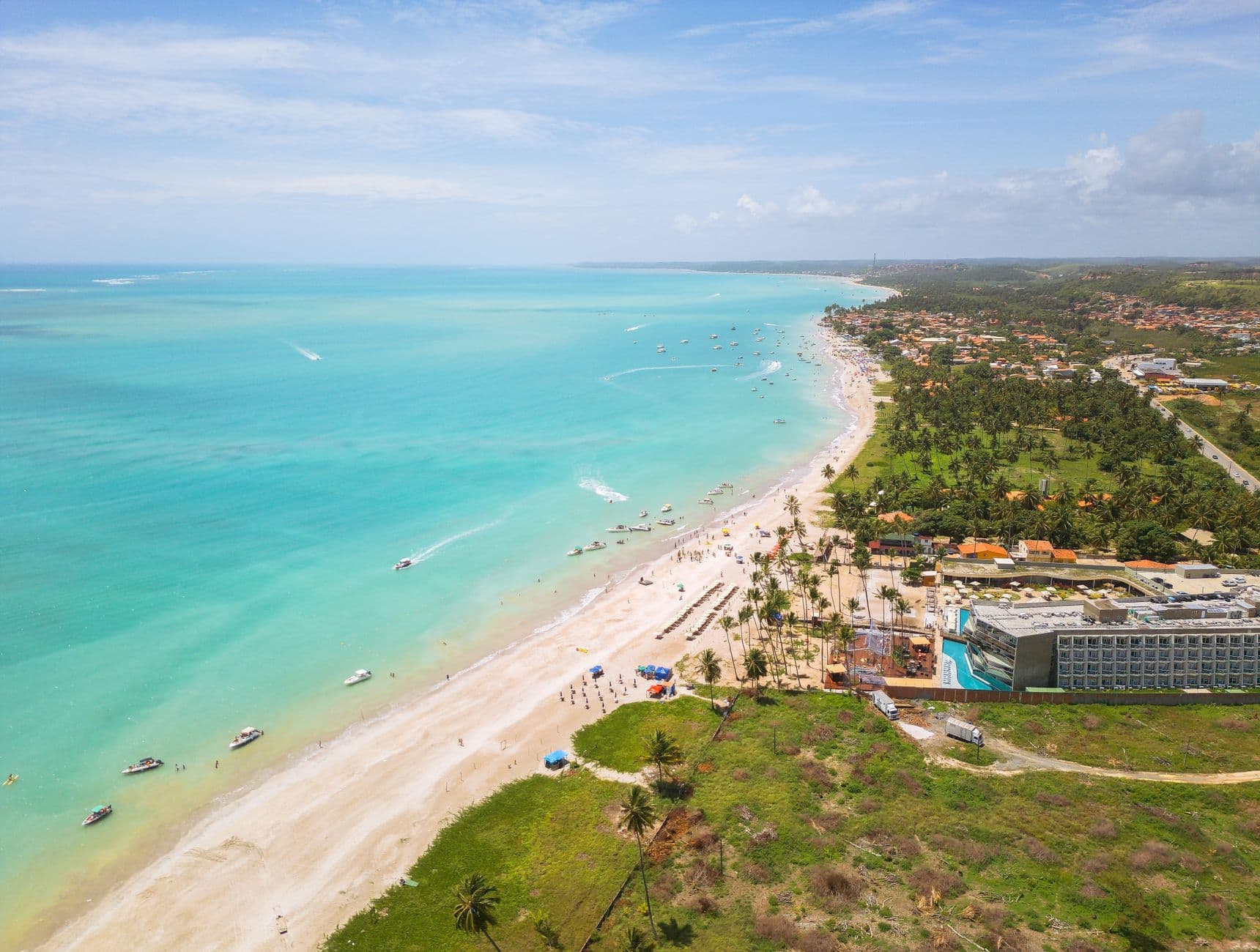 Stunning aerial view of Antunes Beach showcasing turquoise waters and lush greenery.