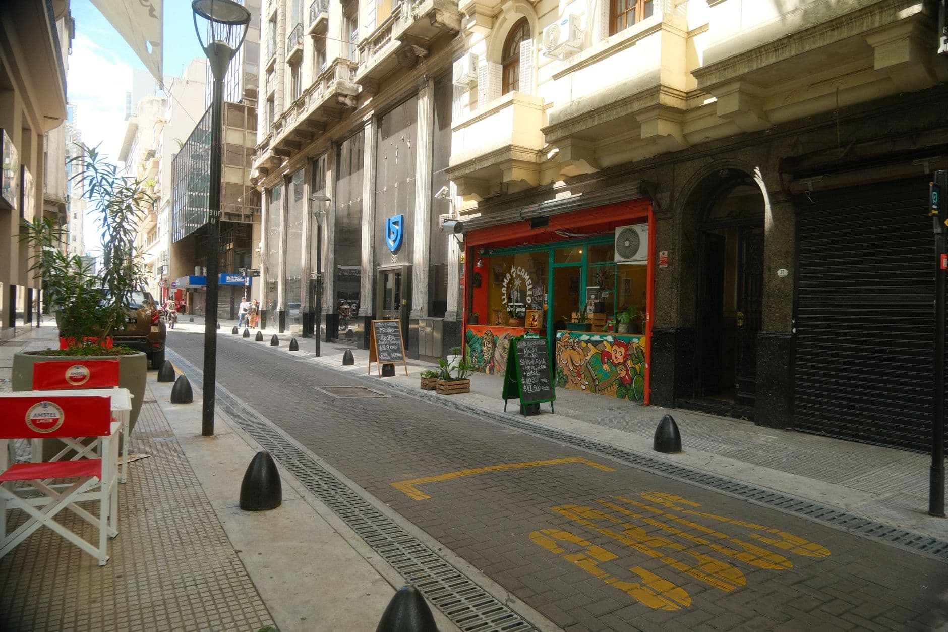 A vibrant street in Buenos Aires with cafes, offering a picturesque city view.