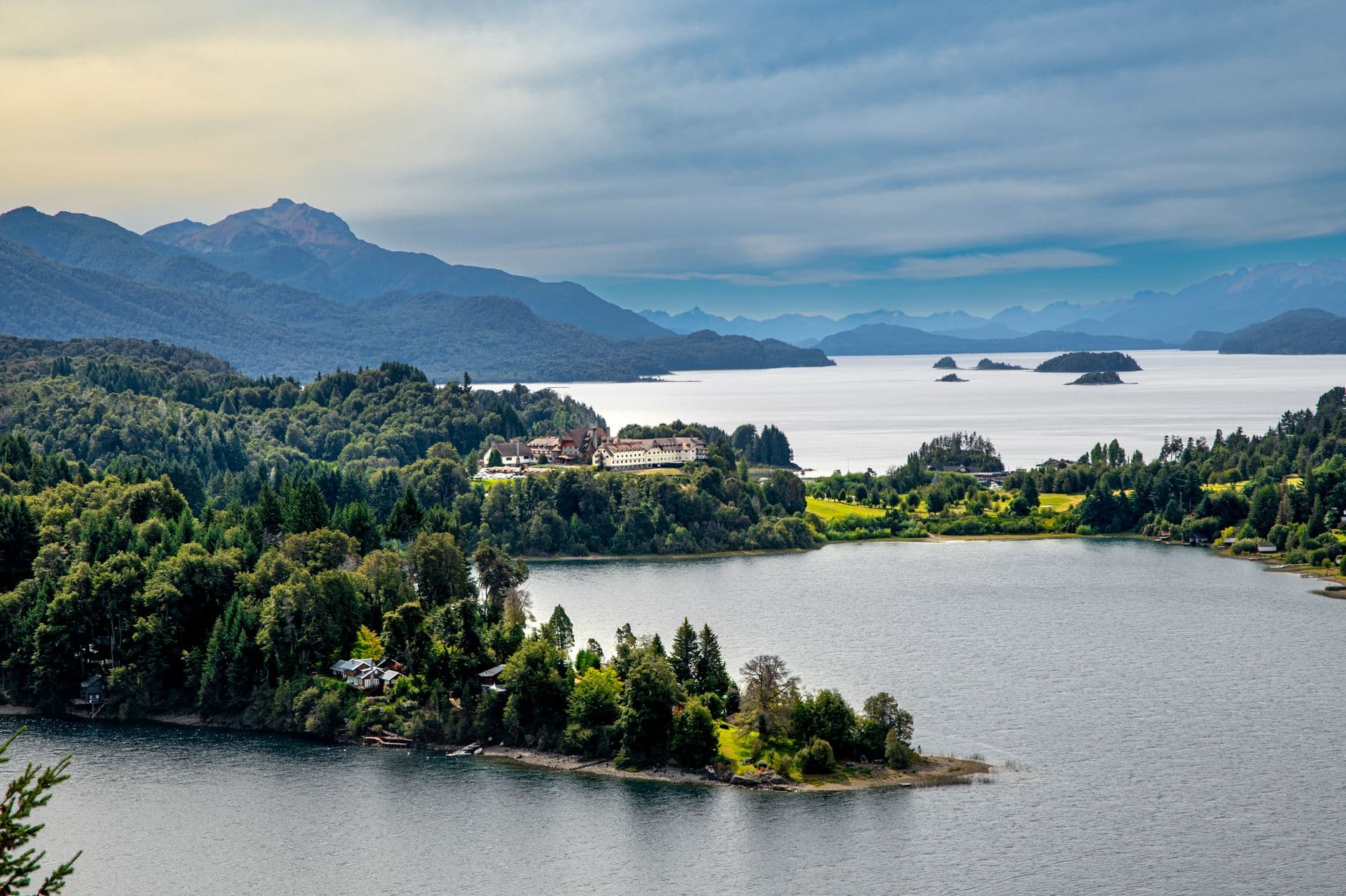 A breathtaking landscape of Nahuel Huapi Lake with lush greenery and the Andes backdrop, capturing serene beauty.