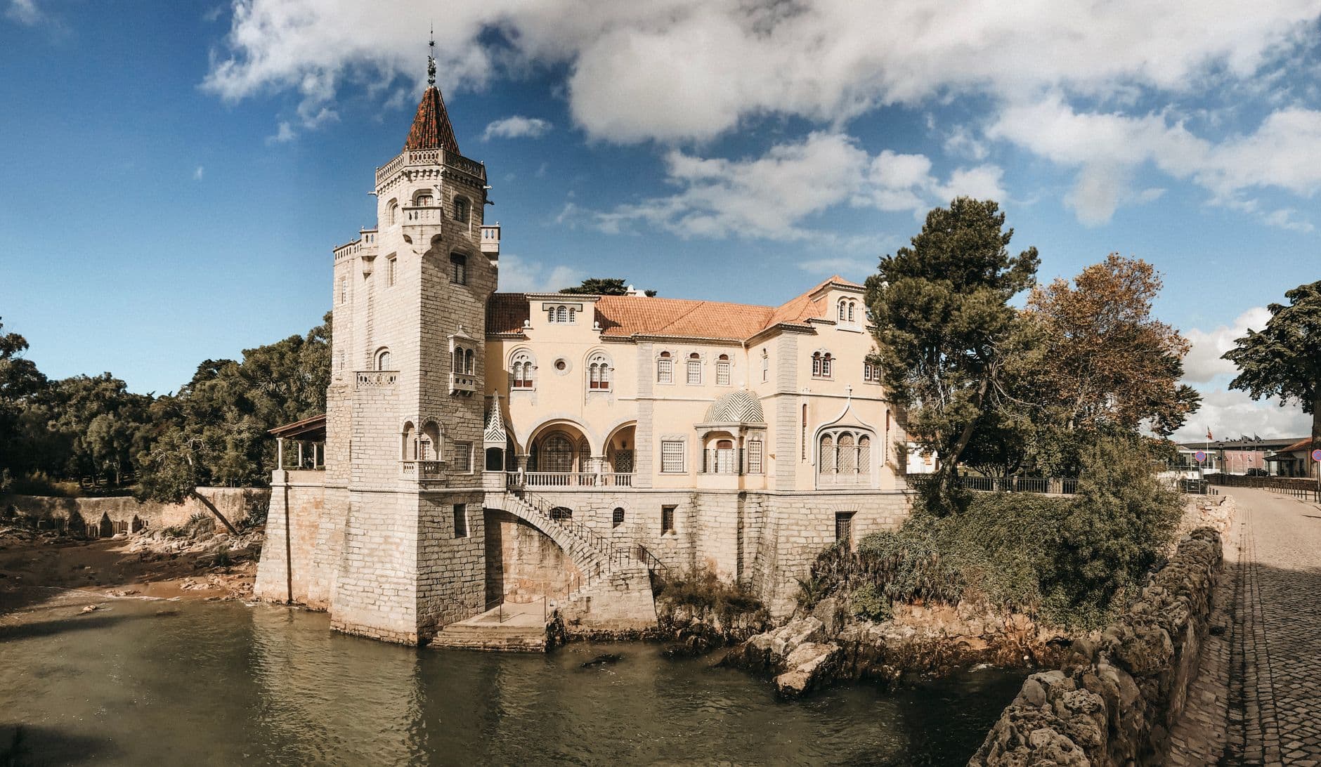 A picturesque historic castle by the river, capturing architectural beauty and serene environment.
