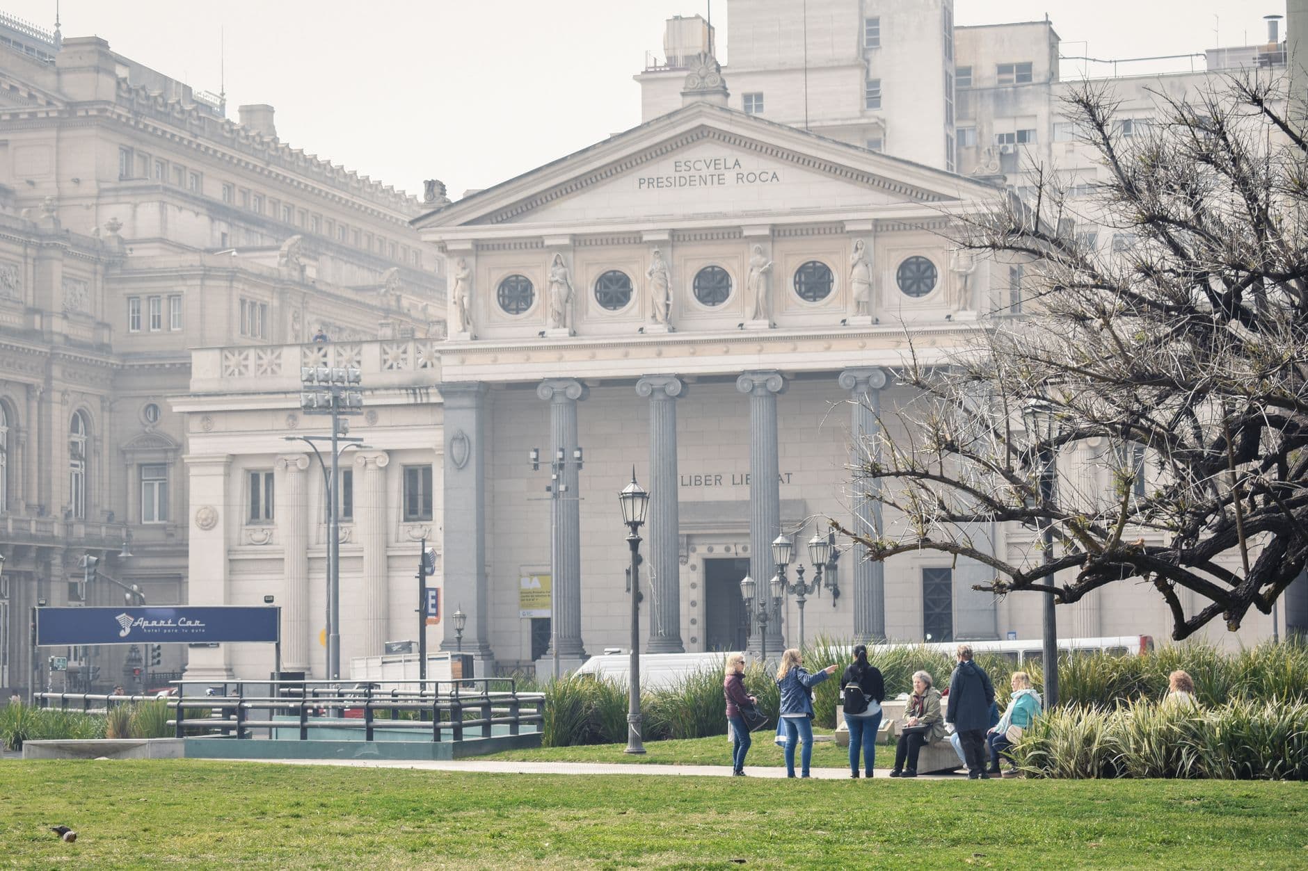People gather at a park near Escuela Presidente Roca in Buenos Aires, Argentina.