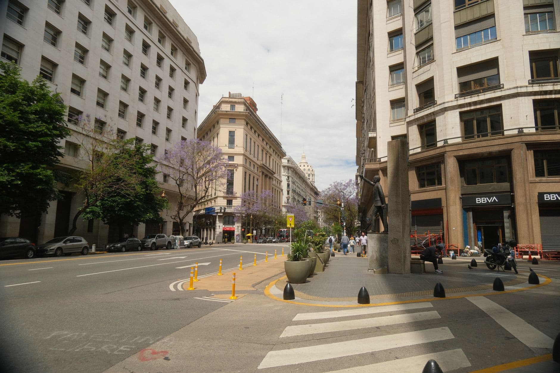 A vibrant street view in Buenos Aires, featuring classic architecture and urban life.