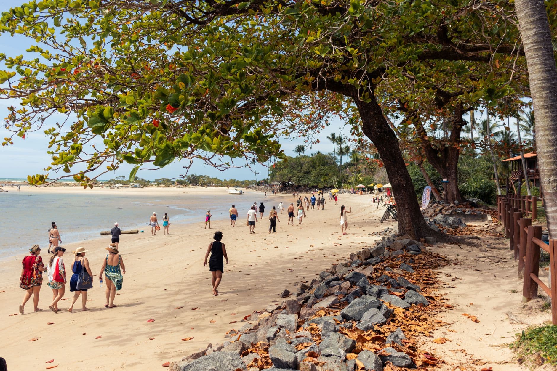 People enjoying a sunny day on the beach at Morro de São Paulo, Bahia, Brazil.